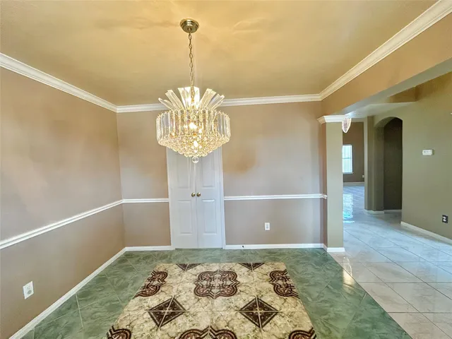 a view of a hallway with a chandelier