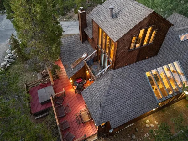 an aerial view of a house roof deck and outdoor seating