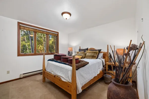 a bed room with a bed and a chair