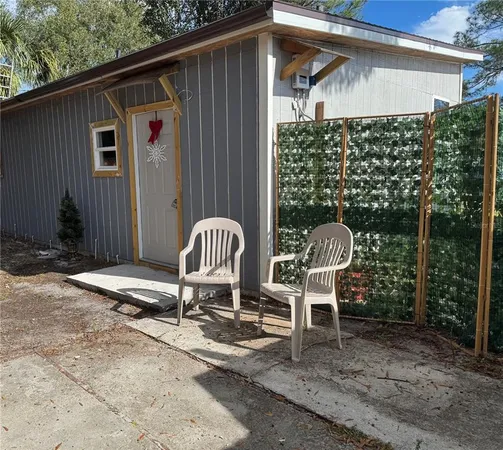 a backyard of a house with table and chairs
