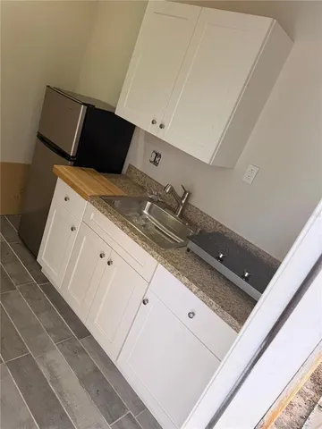 a view of a backyard with a small cabin and a chair