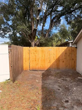 a view of backyard with large tree