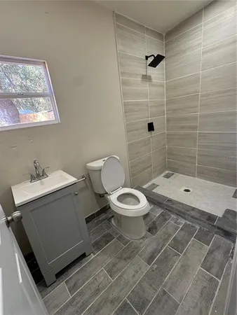 a bathroom with a toilet sink and shower