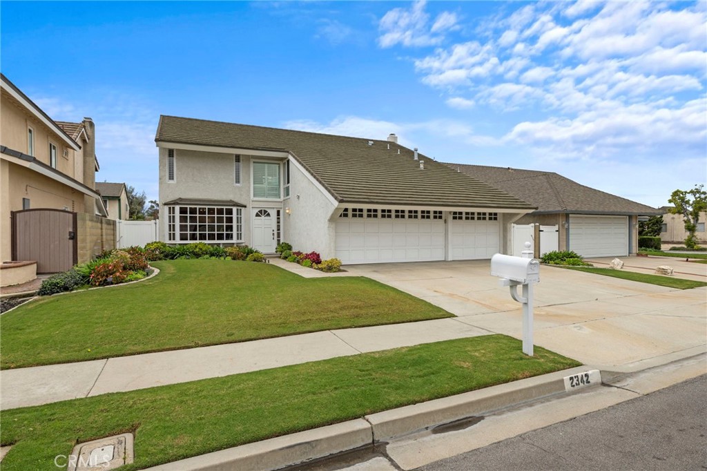 2342 Caper Tree Drive Tustin, CA 92780 - Photo 2 of 44 a front view of a house with a yard