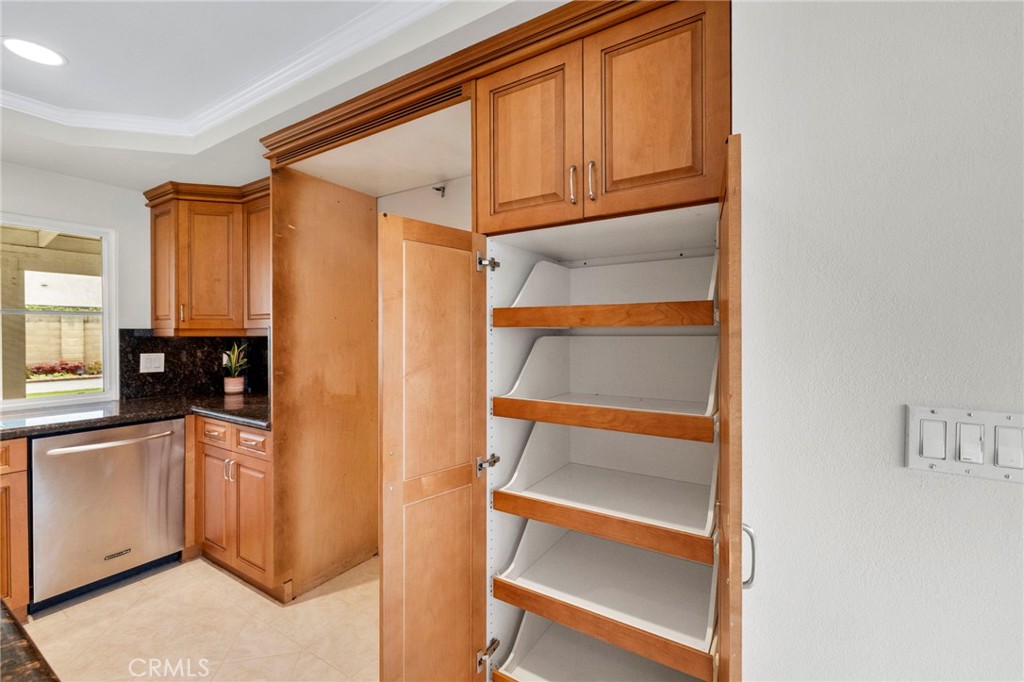 2342 Caper Tree Drive Tustin, CA 92780 - Photo 22 of 44 a kitchen with a refrigerator and cabinets