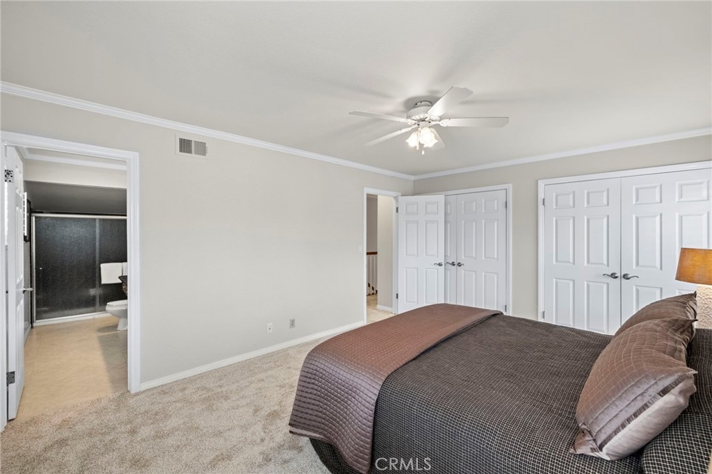 2342 Caper Tree Drive Tustin, CA 92780 - Photo 28 of 44 a bedroom with a bed and a chandelier