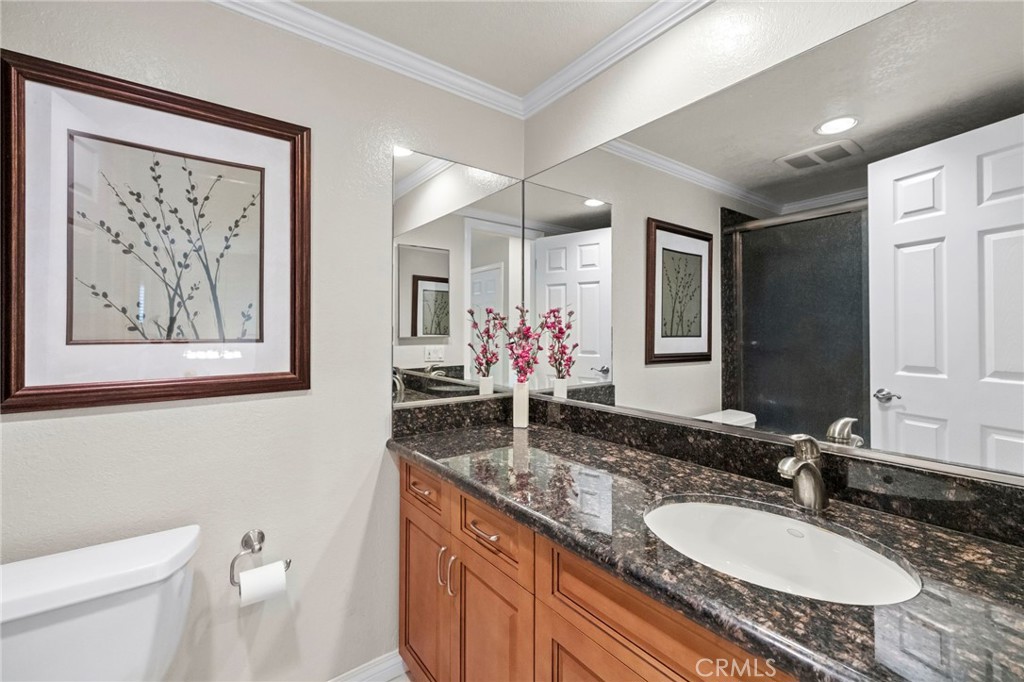 2342 Caper Tree Drive Tustin, CA 92780 - Photo 29 of 44 a bathroom with a granite countertop sink and a mirror