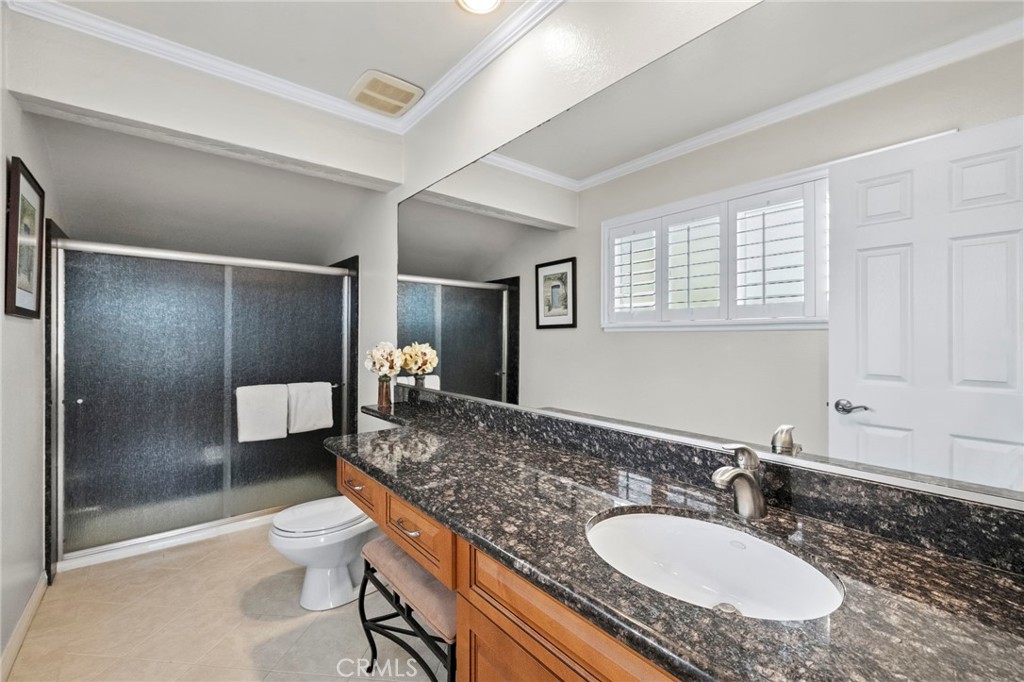 2342 Caper Tree Drive Tustin, CA 92780 - Photo 30 of 44 a bathroom with a granite countertop sink toilet and shower