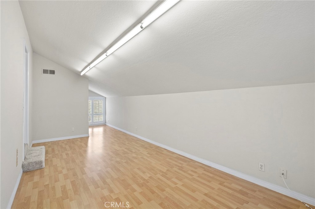 2342 Caper Tree Drive Tustin, CA 92780 - Photo 38 of 44 a view of an empty room with wooden floor