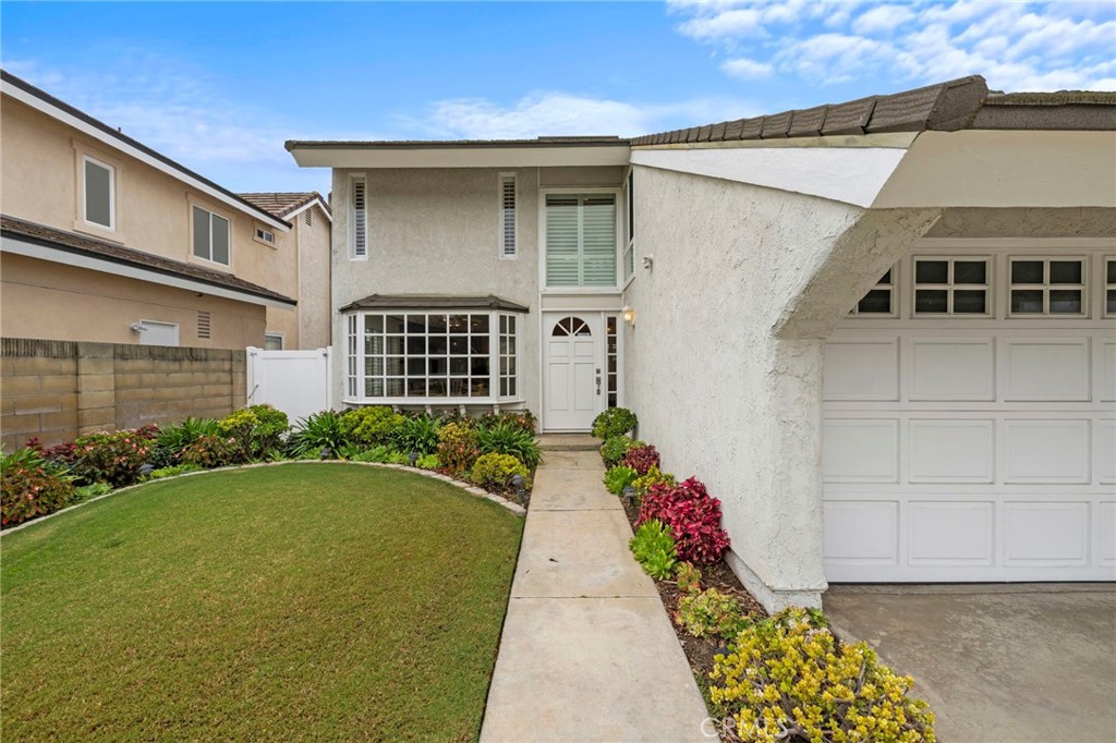 2342 Caper Tree Drive Tustin, CA 92780 - Photo 44 of 44 a front view of a house with a yard