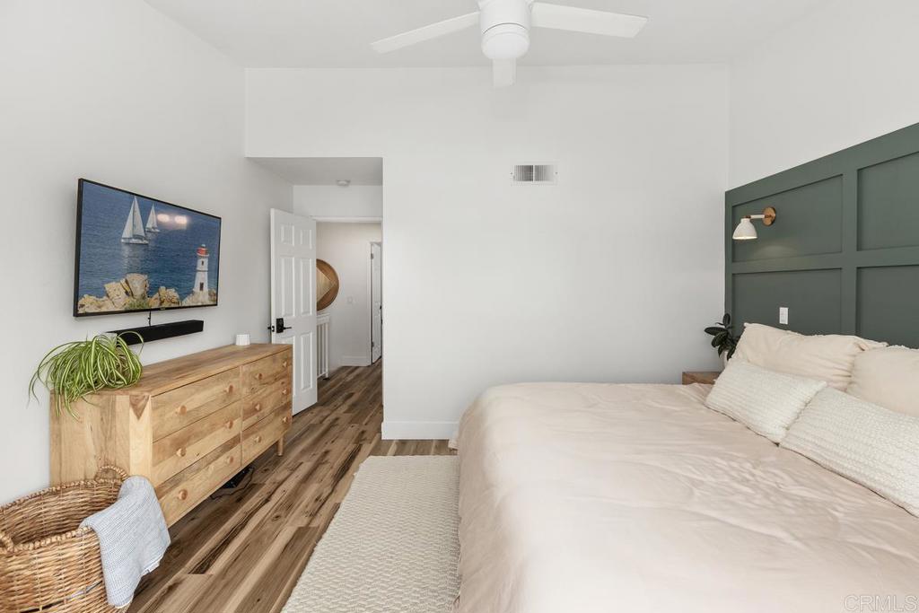 6868 Pear Tree Drive Carlsbad, CA 92011 - Photo 20 of 40 a bedroom with a bed and a flat screen tv