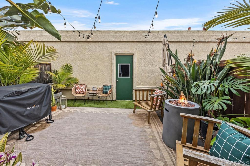 6868 Pear Tree Drive Carlsbad, CA 92011 - Photo 25 of 40 a view of a porch with furniture and a yard