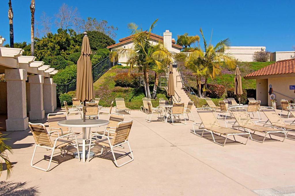 6868 Pear Tree Drive Carlsbad, CA 92011 - Photo 39 of 40 a view of a patio with a table and chairs under an umbrella