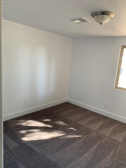 1706 West Colt Road Chandler, AZ 85224 - Photo 19 of 35 an empty room with a white wall and window