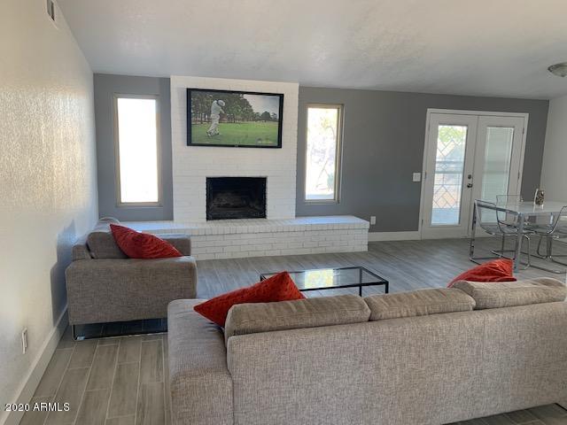 1706 West Colt Road Chandler, AZ 85224 - Photo 2 of 35 a living room with furniture and a fireplace