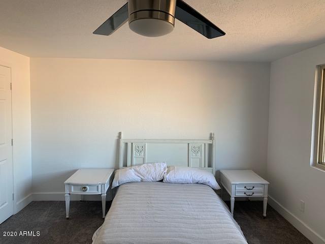 1706 West Colt Road Chandler, AZ 85224 - Photo 21 of 35 a bedroom with a bed and wooden floor