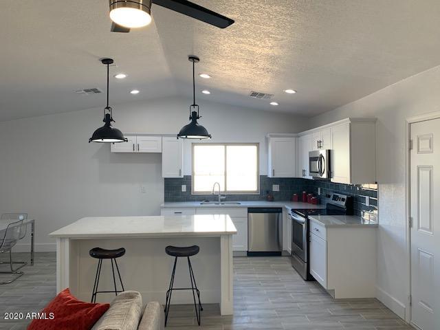 1706 West Colt Road Chandler, AZ 85224 - Photo 24 of 35 a kitchen with a sink stainless steel appliances and cabinets