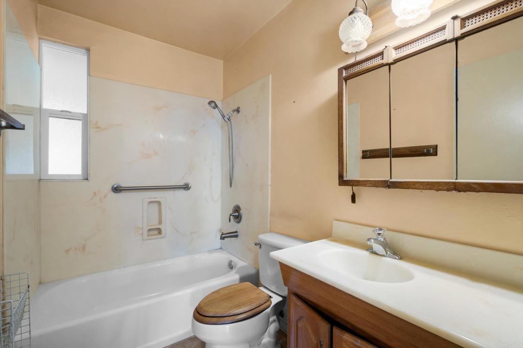 1696 Bartram Way El Cajon, CA 92019 - Photo 12 of 35 a bathroom with a sink toilet a mirror and shower