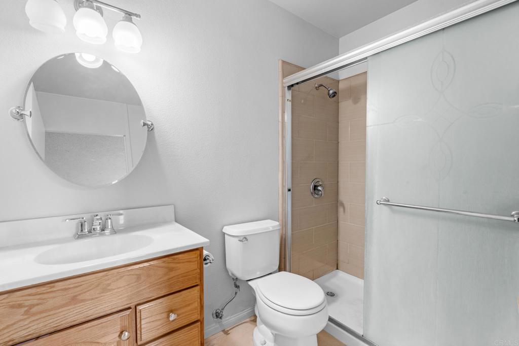 1696 Bartram Way El Cajon, CA 92019 - Photo 15 of 35 a bathroom with a granite countertop sink toilet and shower