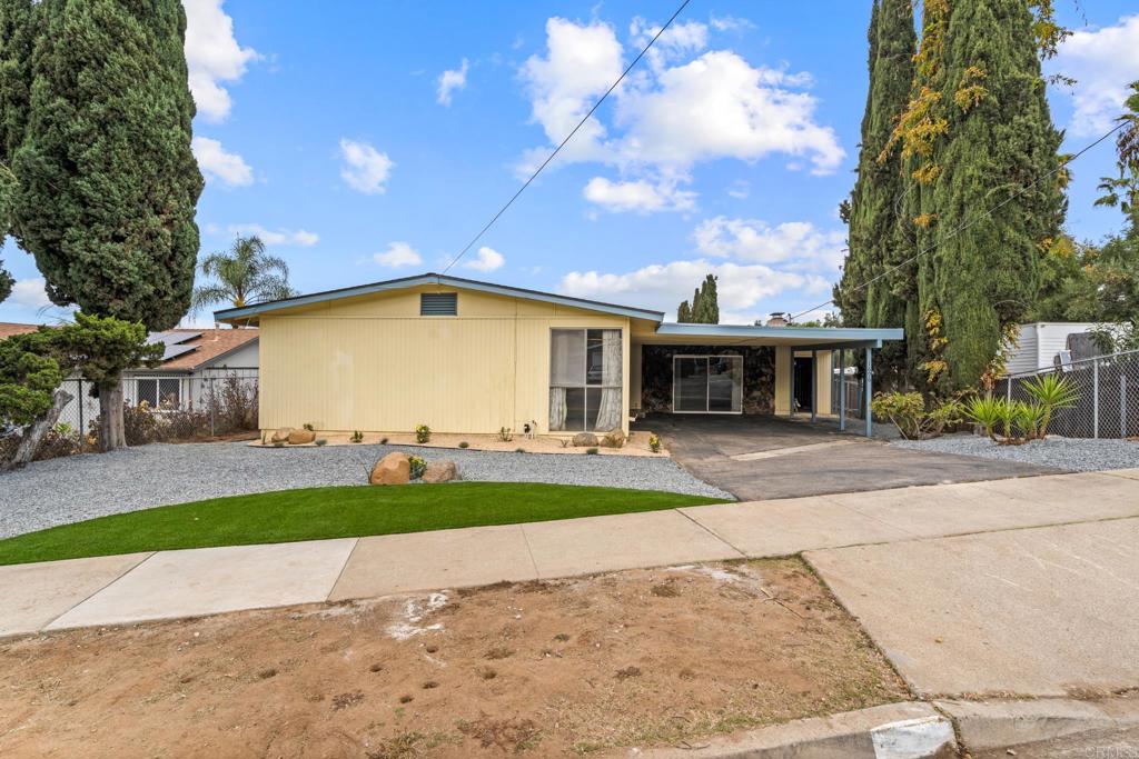 1696 Bartram Way El Cajon, CA 92019 - Photo 25 of 35 a view of a white house with a yard and large tree