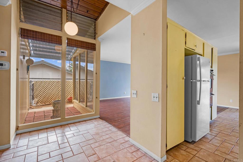 1696 Bartram Way El Cajon, CA 92019 - Photo 4 of 35 a view of a hallway with wooden floor and dining room view
