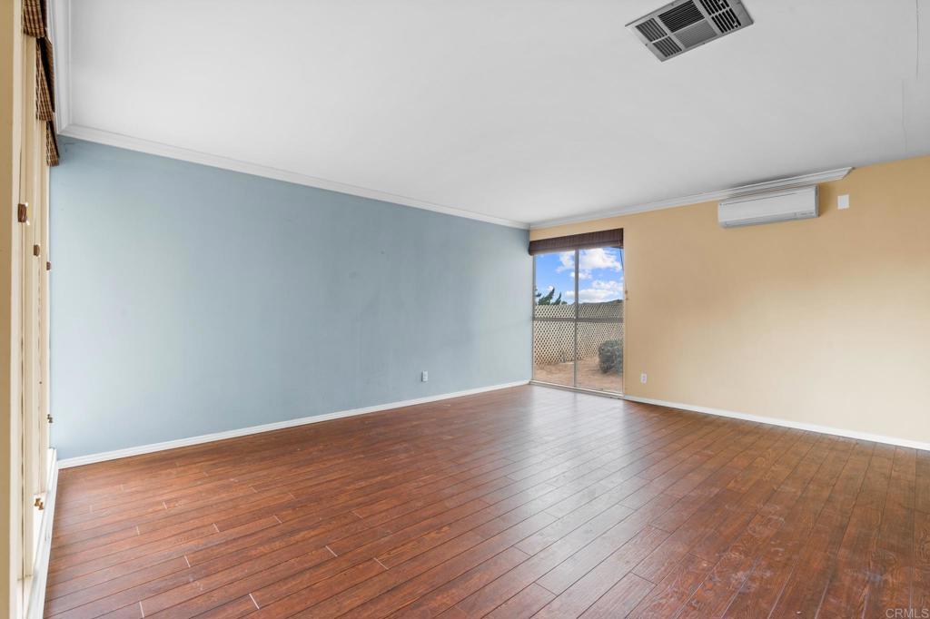 1696 Bartram Way El Cajon, CA 92019 - Photo 5 of 35 a view of an empty room with wooden floor and a window