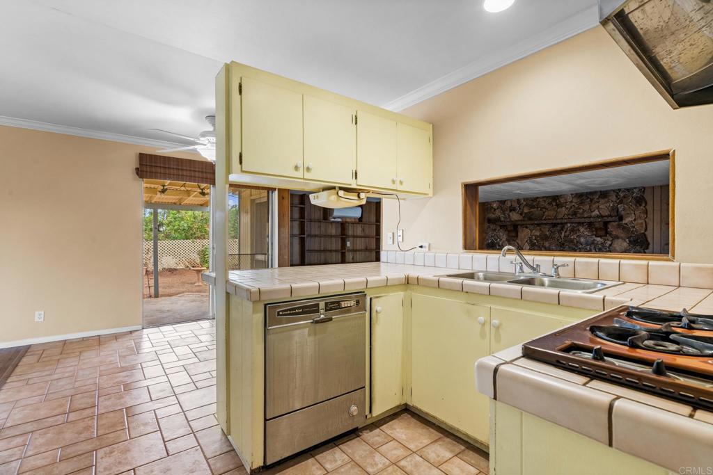 1696 Bartram Way El Cajon, CA 92019 - Photo 9 of 35 a kitchen with a stove a sink and a microwave