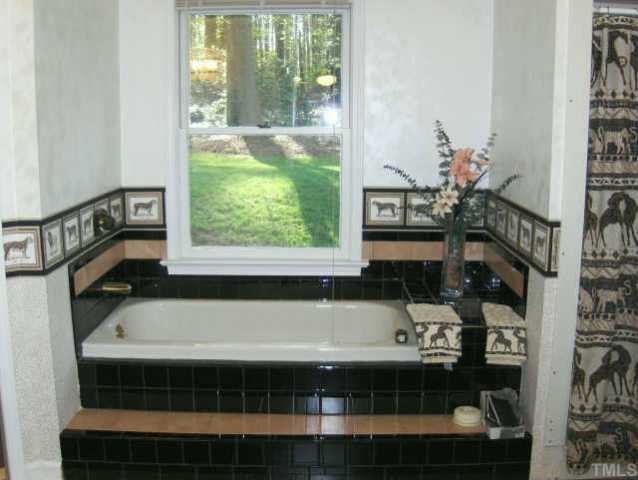 120 Singleton Street Raleigh, NC 27606 - Photo 11 of 12 a bathroom with a bathtub and a window