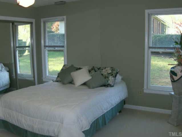 120 Singleton Street Raleigh, NC 27606 - Photo 10 of 12 a bedroom with a bed and a window