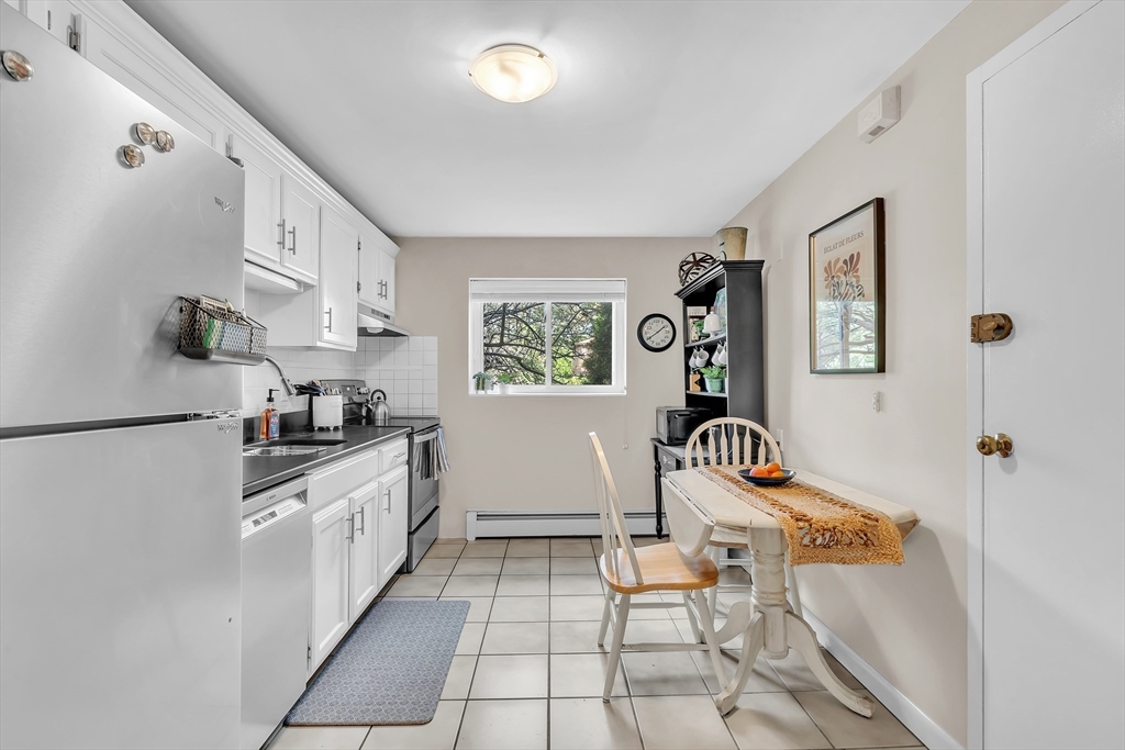 22 Bryon Road, Unit 1 Boston, MA 02467 - Photo 1 of 19 a kitchen with granite countertop a refrigerator and a stove top oven