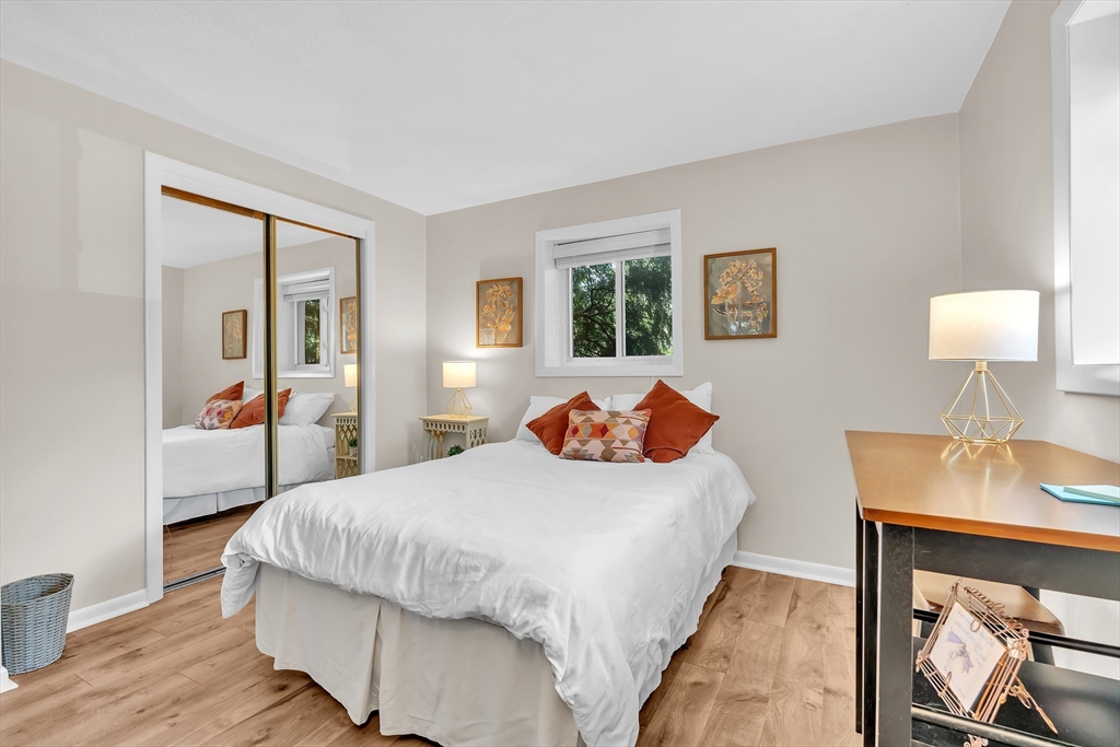 22 Bryon Road, Unit 1 Boston, MA 02467 - Photo 12 of 19 a bedroom with a bed and a table