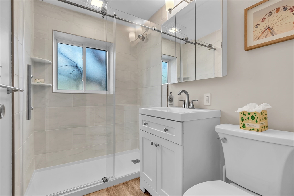 22 Bryon Road, Unit 1 Boston, MA 02467 - Photo 13 of 19 a bathroom with a sink toilet vanity and tub