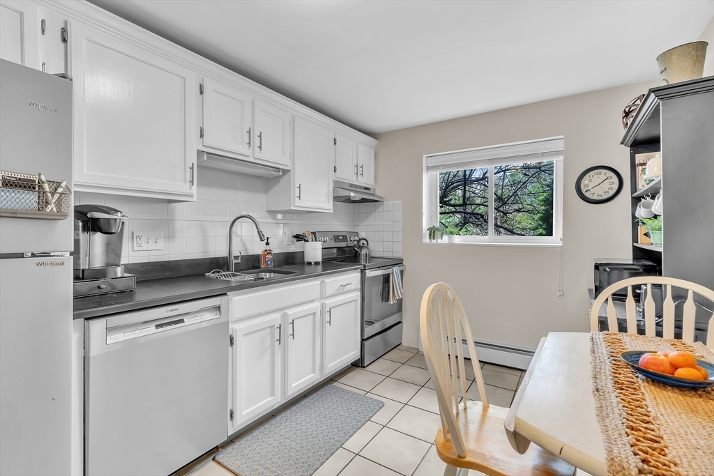 22 Bryon Road, Unit 1 Boston, MA 02467 - Photo 2 of 19 a kitchen with stainless steel appliances granite countertop a sink and cabinets