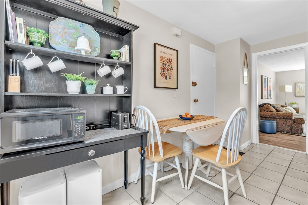 22 Bryon Road, Unit 1 Boston, MA 02467 - Photo 3 of 19 a dining room with furniture and wooden floor