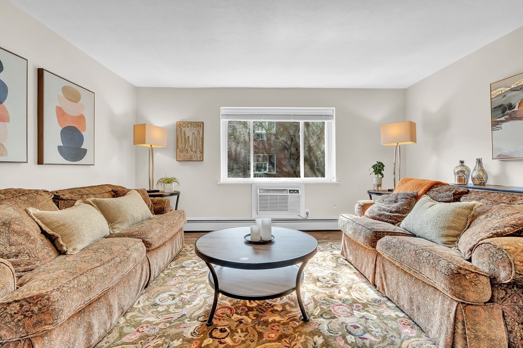 22 Bryon Road, Unit 1 Boston, MA 02467 - Photo 6 of 19 a living room with furniture and a large window