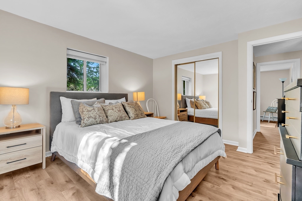 22 Bryon Road, Unit 1 Boston, MA 02467 - Photo 10 of 19 a bedroom with bed and a night stand