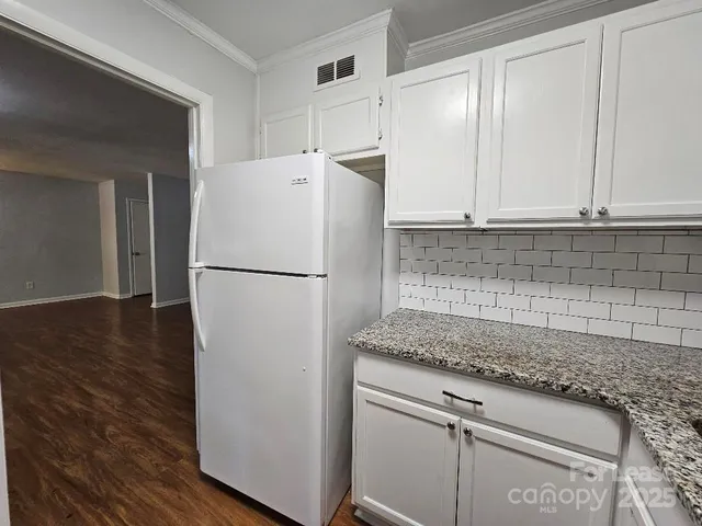 a white refrigerator freezer sitting inside of a kitchen