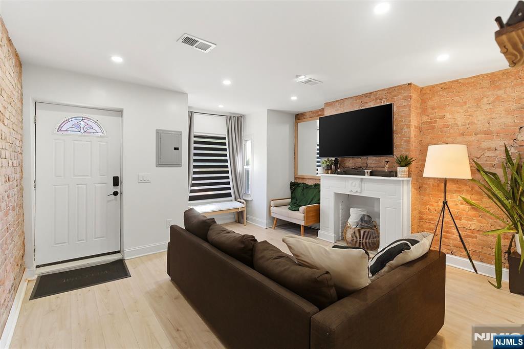 22 8th Avenue Newark, NJ 07104 - Photo 3 of 26 a living room with furniture and a flat screen tv