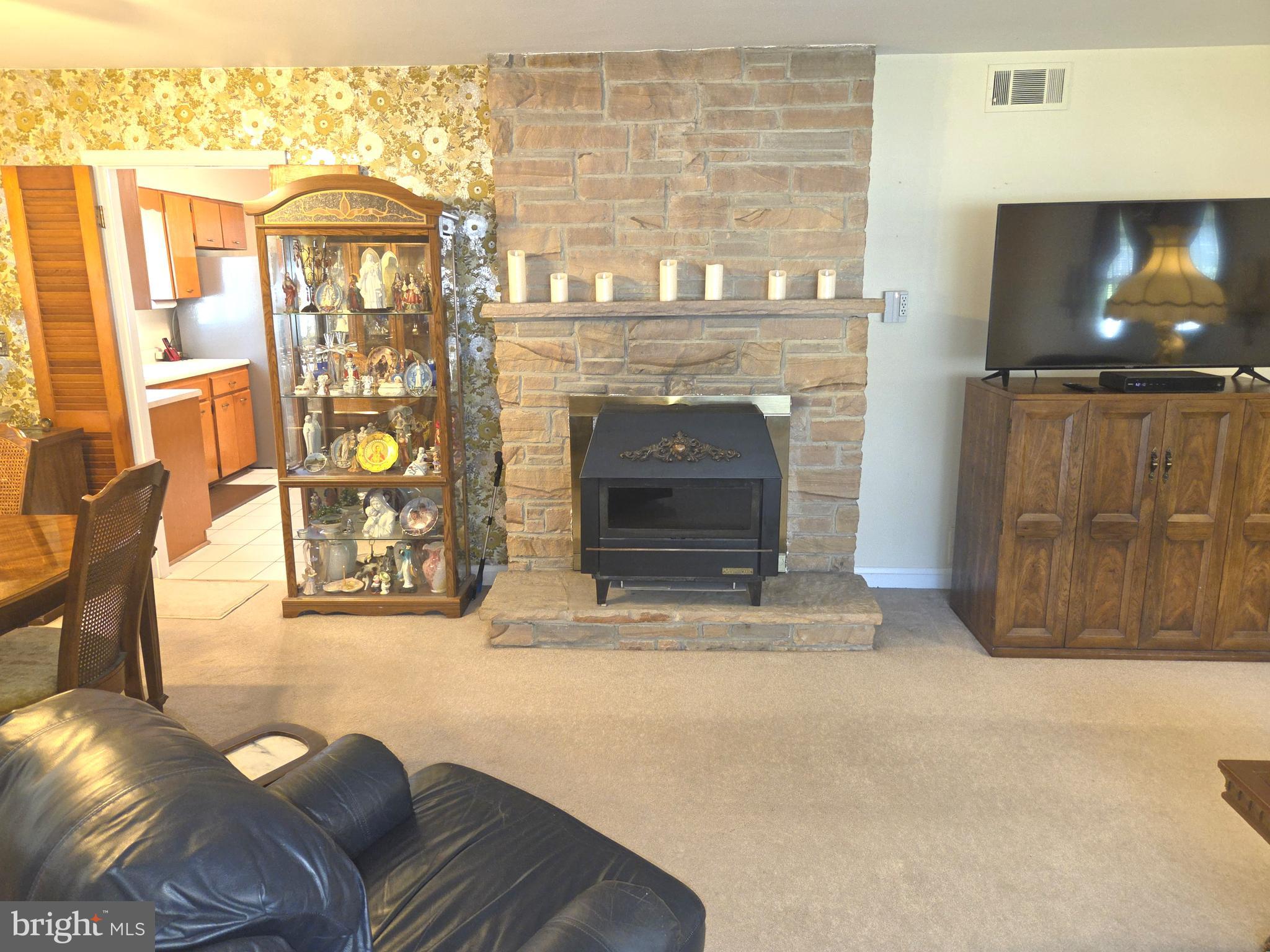 305 Bowleys Quarters Road Middle River, MD 21220 - Photo 24 of 55 a living room with furniture a flat screen tv and a fireplace