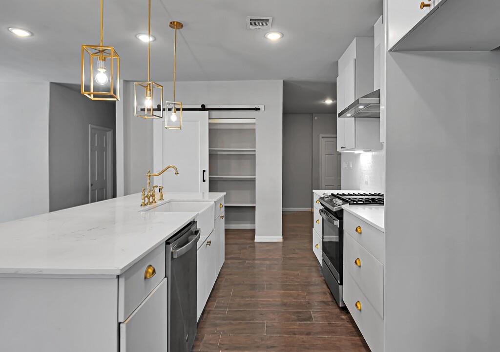2001 Colcord Avenue Waco, TX 76707 - Photo 11 of 27 a kitchen with a sink stove and refrigerator