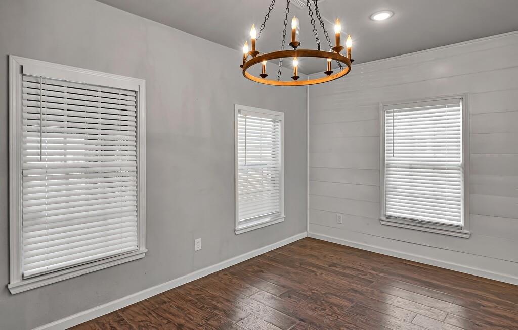 2001 Colcord Avenue Waco, TX 76707 - Photo 13 of 27 a view of an empty room with wooden floor and a window