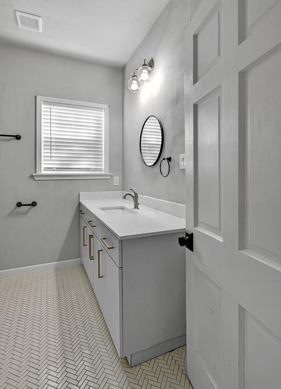 2001 Colcord Avenue Waco, TX 76707 - Photo 20 of 27 a bathroom with a double vanity sink a vanity and a mirror