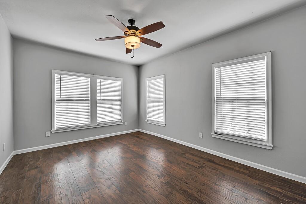 2001 Colcord Avenue Waco, TX 76707 - Photo 22 of 27 a view of an empty room with wooden floor and a window