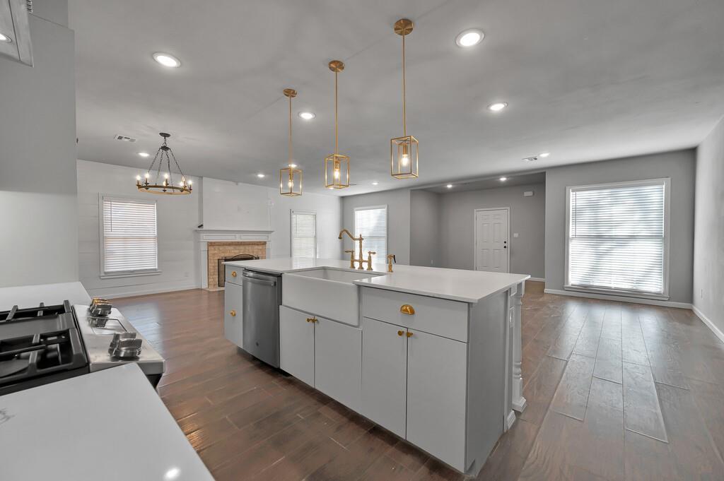 2001 Colcord Avenue Waco, TX 76707 - Photo 7 of 27 a large kitchen with kitchen island a sink a stove a dining table and chairs