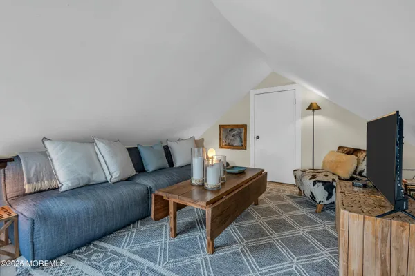 a living room with furniture a flat screen tv and rug