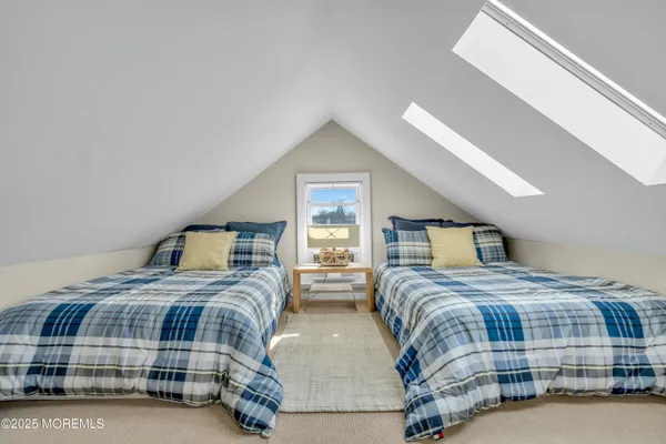 a bedroom with two beds and a night stand