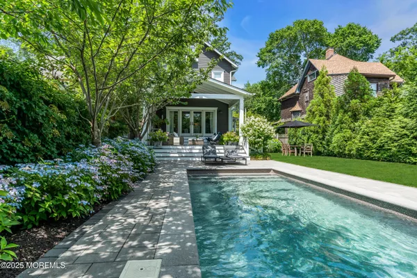 a view of a house with backyard sitting area and garden