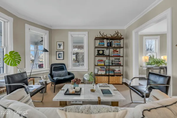 a living room with furniture and a book shelf