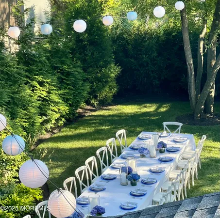 a view of a table and chairs in backyard