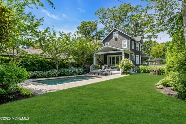 a front view of a house with yard and green space